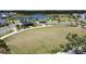 Beautiful community park with walking path, lush green space, and a covered seating area near the lake at 6514 Barnstorm Way, St Cloud, FL 34771