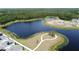 Scenic aerial view of a serene pond and walking paths, offering a peaceful retreat within the neighborhood at 6514 Barnstorm Way, St Cloud, FL 34771