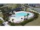 Aerial view of a resort-style community pool with lounge chairs, umbrellas, and a covered pavilion at 6514 Barnstorm Way, St Cloud, FL 34771