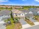 Beautiful aerial view of a home with a well-maintained yard, lake views, and lush greenery at 7211 Oakmoss Loop, Davenport, FL 33837