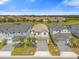 Aerial shot of houses with manicured lawns, paver driveways, and water views at 7211 Oakmoss Loop, Davenport, FL 33837
