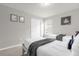 Bright bedroom featuring two twin beds, neutral walls, carpet, and charming decorative artwork at 7211 Oakmoss Loop, Davenport, FL 33837