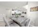 Charming dining area with marble table and views into the kitchen at 7211 Oakmoss Loop, Davenport, FL 33837