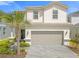 Charming two-story home with well-manicured landscaping and a two-car garage at 7211 Oakmoss Loop, Davenport, FL 33837