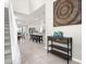 Inviting foyer with a staircase, decor and open view to kitchen at 7211 Oakmoss Loop, Davenport, FL 33837