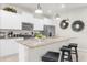 Modern kitchen with stainless steel appliances, granite countertops, pendant lighting, and breakfast bar with seating at 7211 Oakmoss Loop, Davenport, FL 33837