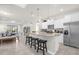 Bright and modern kitchen with a central island and stainless steel appliances at 7211 Oakmoss Loop, Davenport, FL 33837