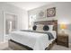 Comfortable main bedroom with a large bed, side tables and decorative lighting at 7211 Oakmoss Loop, Davenport, FL 33837