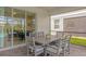 Covered patio with dining area featuring a gray table and chairs at 7211 Oakmoss Loop, Davenport, FL 33837