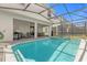 Stunning screened-in pool and spa with outdoor seating and BBQ area at 7211 Oakmoss Loop, Davenport, FL 33837