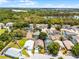 Aerial view of a home with a beautiful backyard, in-ground pool, and the community surrounded by lush green trees at 829 Clear Creek Cir, Clermont, FL 34714