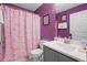 Vibrant bathroom with gray vanity, white sink and framed mirror at 829 Clear Creek Cir, Clermont, FL 34714