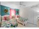 Bright bedroom featuring two twin beds, playful decor and ceiling fan at 829 Clear Creek Cir, Clermont, FL 34714