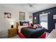 Bedroom featuring a large bed, Mickey Mouse decor and ceiling fan at 829 Clear Creek Cir, Clermont, FL 34714