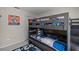 Bedroom featuring bunkbeds, door, and gray walls at 829 Clear Creek Cir, Clermont, FL 34714