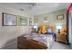 Cozy bedroom features a wooden bed frame, ceiling fan, and colorful Winnie the Pooh themed decor for a warm and inviting space at 829 Clear Creek Cir, Clermont, FL 34714