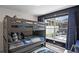 Bedroom featuring bunkbeds, large window, and dark accent wall at 829 Clear Creek Cir, Clermont, FL 34714