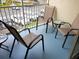 Relax on this screened balcony with comfortable seating and views of the community at 8809 Dunes Ct # 201, Kissimmee, FL 34747