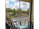 Outdoor balcony with seating offers serene views of community and parking at 8809 Dunes Ct # 201, Kissimmee, FL 34747