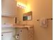 Bright bathroom with vanity, mirror, and white fixtures. Towels are available on the rack at 8809 Dunes Ct # 201, Kissimmee, FL 34747