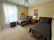 Neutral bedroom featuring two twin beds, beige carpet, and ceiling fan at 8809 Dunes Ct # 201, Kissimmee, FL 34747