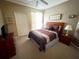 Unwind in this bedroom featuring a ceiling fan, closet, nightstand, and a window with curtains at 8809 Dunes Ct # 201, Kissimmee, FL 34747