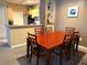 This dining room shows off a wood table with seating for six, and a view into the kitchen at 8809 Dunes Ct # 201, Kissimmee, FL 34747