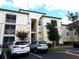 Condo building with multiple parking spaces and view of sky at 8809 Dunes Ct # 201, Kissimmee, FL 34747