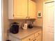 Kitchen counter area including cabinets, blender, coffee machine, and water heater at 8809 Dunes Ct # 201, Kissimmee, FL 34747