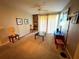 Relax in this living room with a ceiling fan, shelving, and sliding glass doors to a patio at 8809 Dunes Ct # 201, Kissimmee, FL 34747