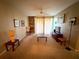 Relax in this spacious living room featuring a ceiling fan and sliding glass doors leading to a patio at 8809 Dunes Ct # 201, Kissimmee, FL 34747