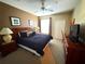 This comfy main bedroom offers a ceiling fan, closet, nightstands, and a television for your convenience at 8809 Dunes Ct # 201, Kissimmee, FL 34747