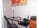 Modern office space featuring a glass desk, office chair, and bright light at 8809 Dunes Ct # 201, Kissimmee, FL 34747