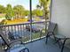 Relaxing patio with four chairs, two tables, and screened views of lush greenery at 8809 Dunes Ct # 201, Kissimmee, FL 34747
