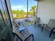 Relaxing patio with four chairs, two tables, and screened views of lush greenery at 8809 Dunes Ct # 201, Kissimmee, FL 34747