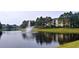Scenic pond view with fountain, reflecting the surrounding community buildings at 8809 Dunes Ct # 201, Kissimmee, FL 34747