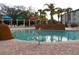 Inviting pool area with colorful cabanas, lush greenery, and comfortable seating at 8809 Dunes Ct # 201, Kissimmee, FL 34747