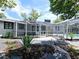 Home exterior with lush landscaping and screened-in enclosure around the pool at 905 W 11Th Ave, Mount Dora, FL 32757