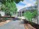 Lush backyard with stone pavers leading to a serene screened-in patio at 905 W 11Th Ave, Mount Dora, FL 32757