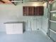 Clean garage space with built-in cabinets and a countertop with drawers, offering ample storage solutions at 905 W 11Th Ave, Mount Dora, FL 32757