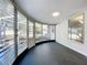 Bright sunroom with jalousie windows and black flooring, offering ample natural light at 905 W 11Th Ave, Mount Dora, FL 32757