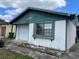 Charming one-story home featuring green trim, a garage, and a well-lit window at 930 Buttercup Dr, Lakeland, FL 33801