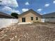Backyard featuring a sliding glass door and fenced perimeter; perfect for outdoor activities and privacy at 352 Madina Cir, Davenport, FL 33837