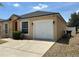 Single-story home featuring an attached garage, well-kept lawn and a brightly painted red front door at 352 Madina Cir, Davenport, FL 33837