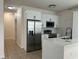 Bright kitchen features stainless steel appliances, granite counters, and white cabinetry at 352 Madina Cir, Davenport, FL 33837
