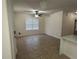 This open living room features neutral paint, tiled floors, and a modern ceiling fan at 352 Madina Cir, Davenport, FL 33837