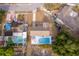 Aerial view highlights a home with a pool, patio space, mature trees, and surrounding residences at 1007 Maya Ave, Orlando, FL 32822