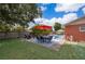 Serene backyard features a dining set, lounge chairs, and a refreshing pool for ultimate outdoor enjoyment at 1007 Maya Ave, Orlando, FL 32822