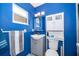 Bathroom with a blue accent wall, mirror, vanity, medicine cabinet, and toilet at 1007 Maya Ave, Orlando, FL 32822
