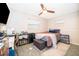 Bedroom with tile flooring, and a bed with a desk and shelving unit at 1007 Maya Ave, Orlando, FL 32822